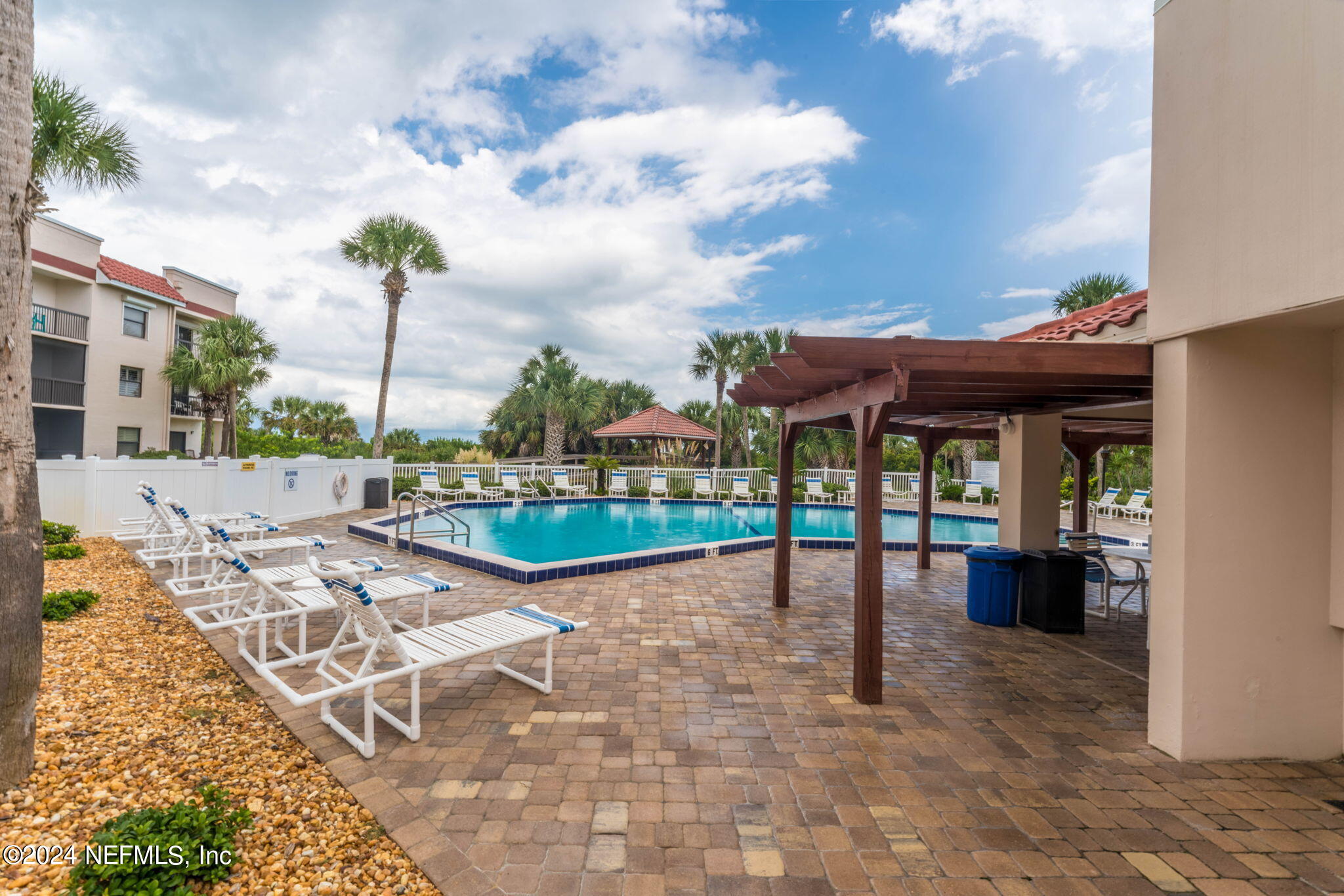 4250 Florida A1A, Unit M35 St. Augustine, FL 32080 - Photo 38 of 57 a view of a patio with a dining table and chairs with wooden floor