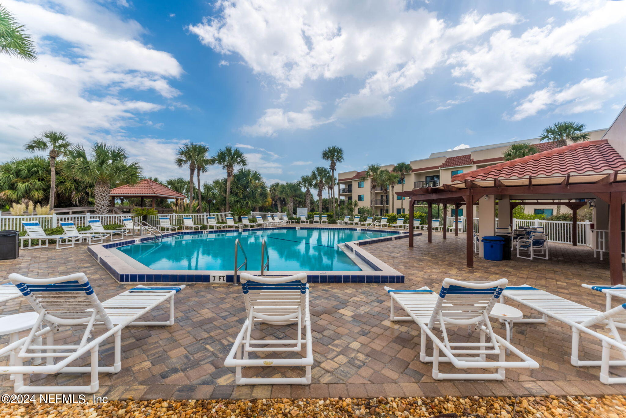 4250 Florida A1A, Unit M35 St. Augustine, FL 32080 - Photo 39 of 57 a view of a swimming pool with lawn chairs and a barbeque