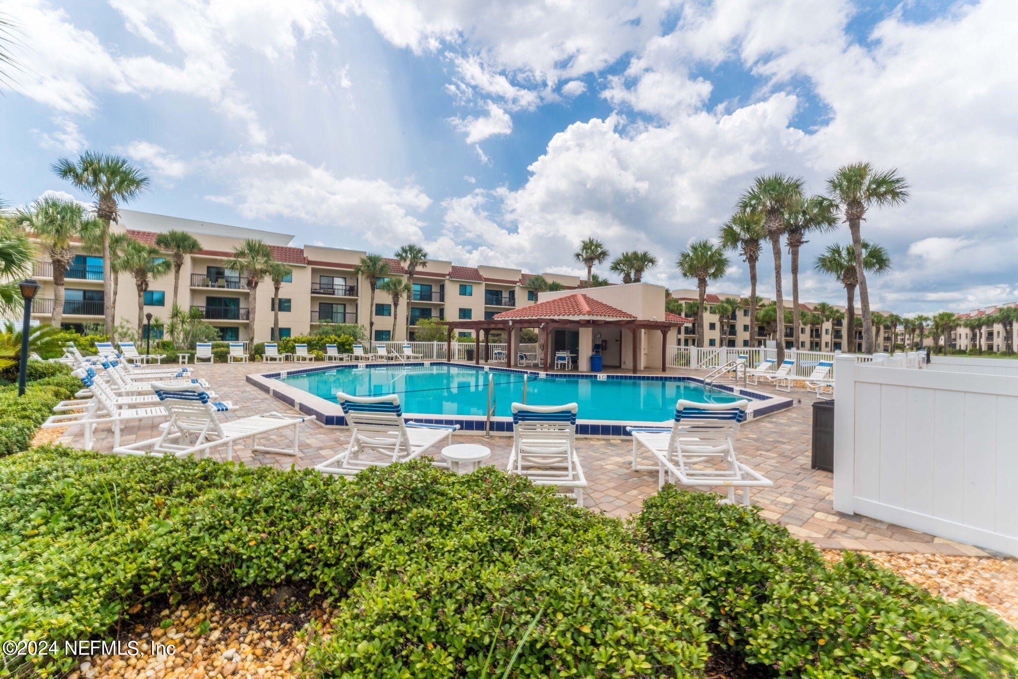 4250 Florida A1A, Unit M35 St. Augustine, FL 32080 - Photo 40 of 57 a view of a swimming pool with lawn chairs and a fire pit