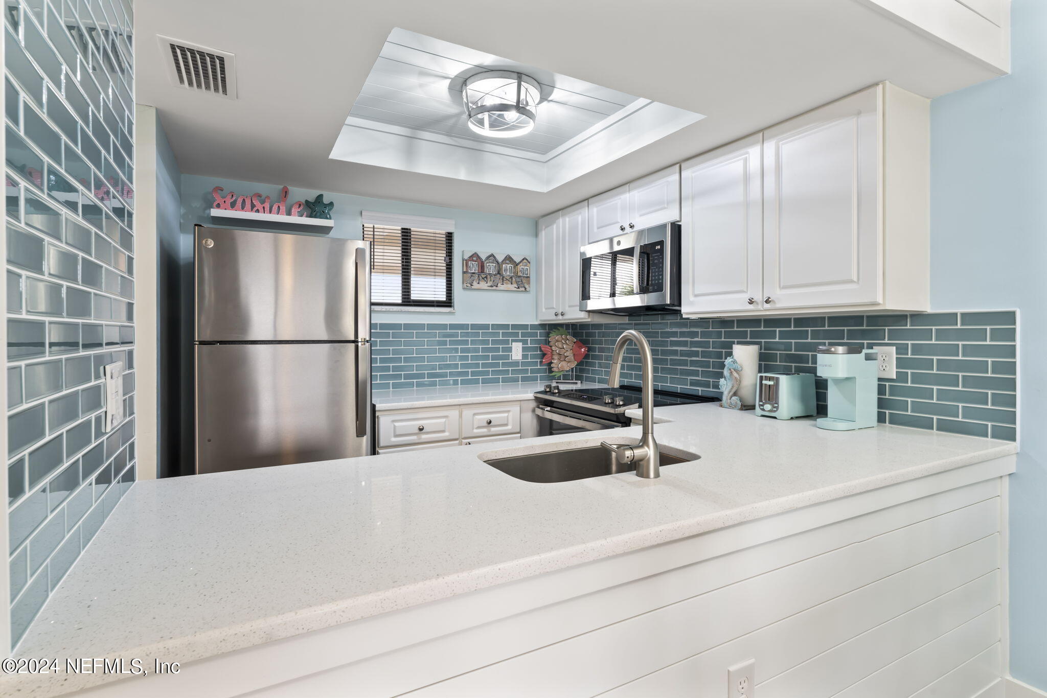 4250 Florida A1A, Unit M35 St. Augustine, FL 32080 - Photo 5 of 57 a kitchen with a sink a refrigerator and cabinets