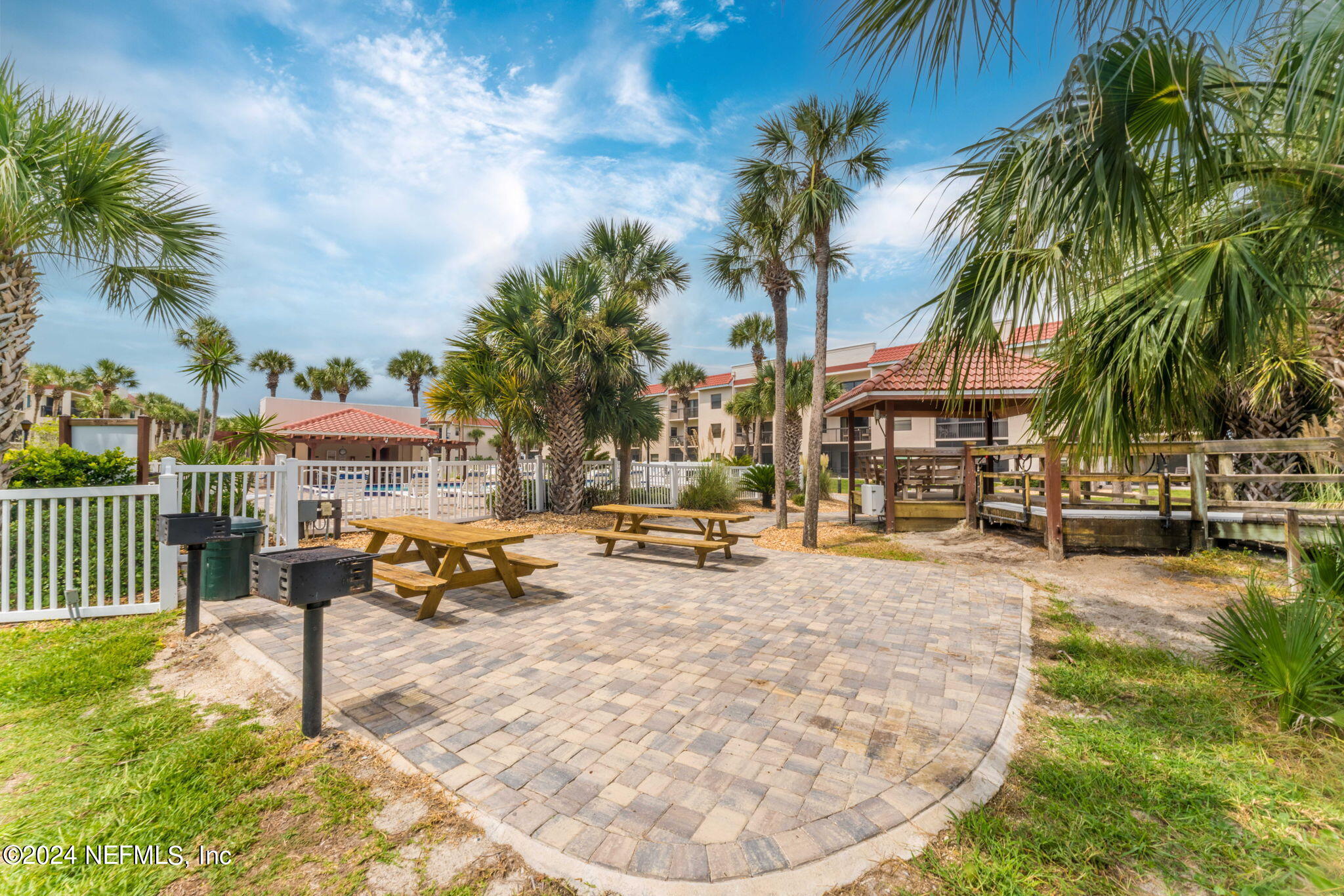 4250 Florida A1A, Unit M35 St. Augustine, FL 32080 - Photo 51 of 57 a view of a swimming pool with a lounge chair and palm trees