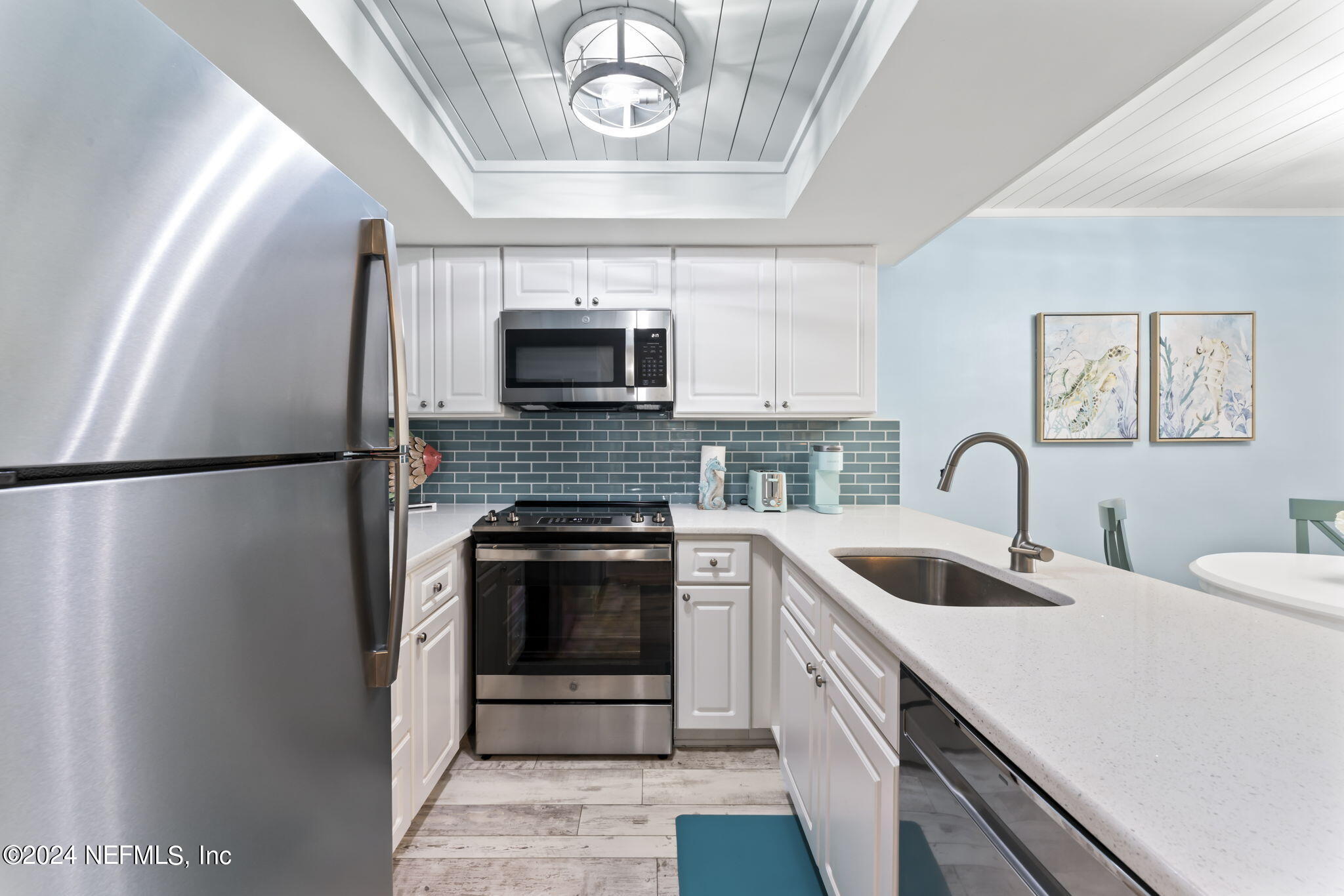 4250 Florida A1A, Unit M35 St. Augustine, FL 32080 - Photo 6 of 57 a kitchen with sink a microwave and cabinets