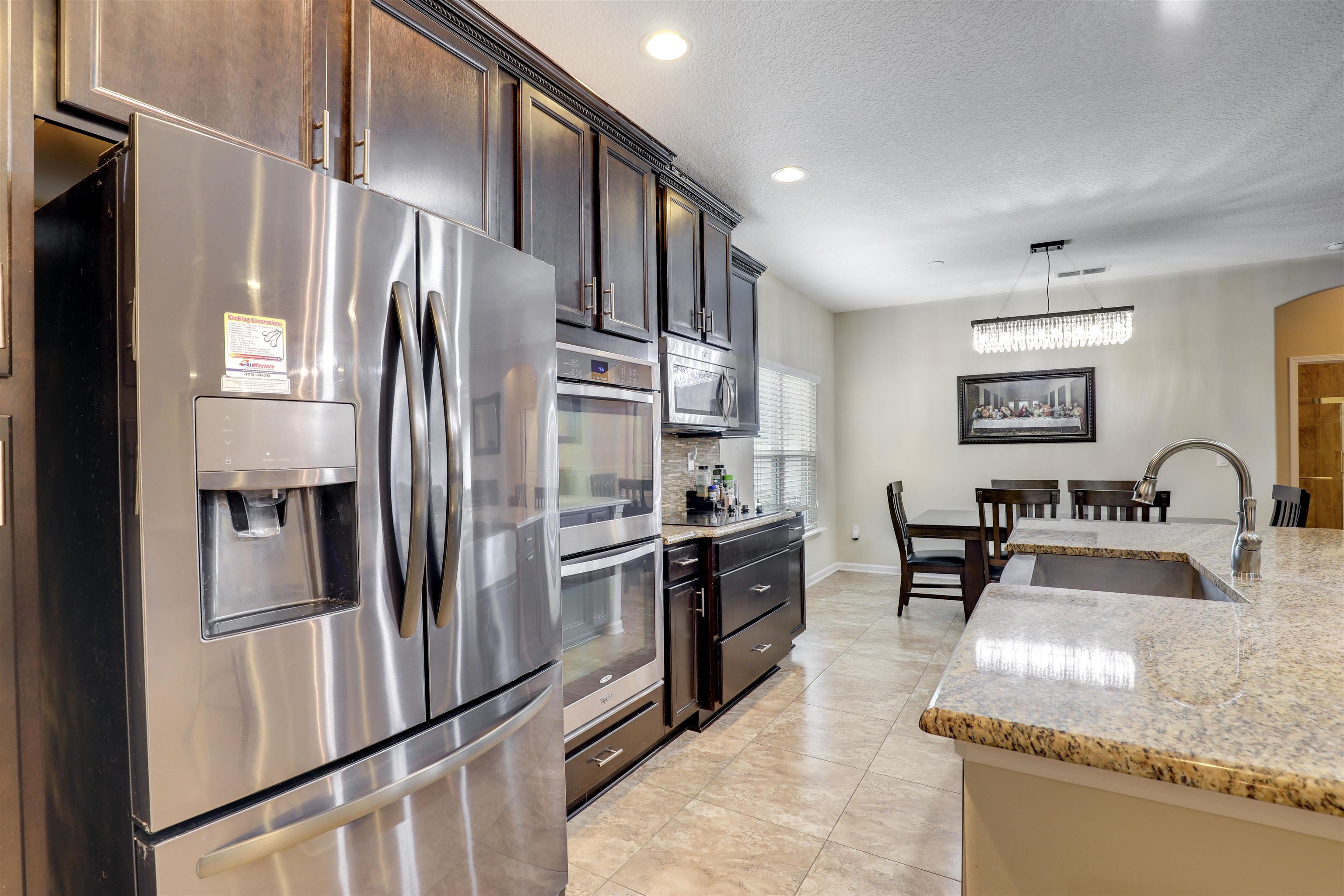 200 Ellsworth Circle St. Johns, FL 32259 - Photo 19 of 58 a kitchen with stainless steel appliances granite countertop a refrigerator a stove and a sink