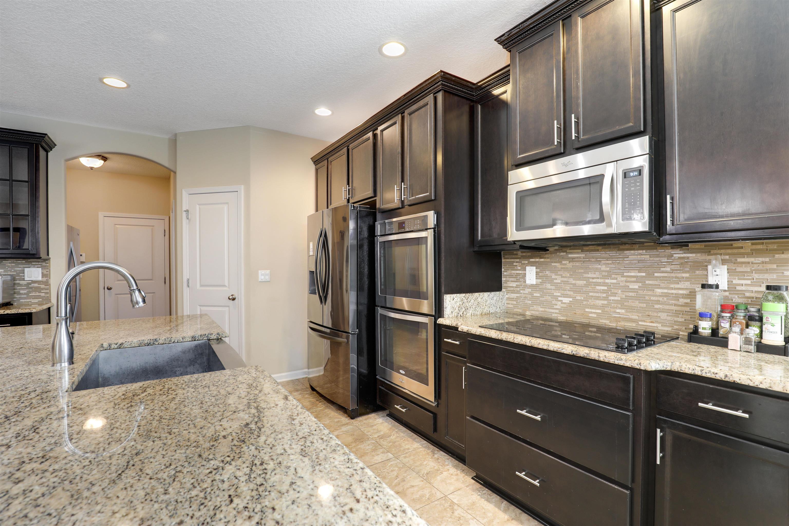 200 Ellsworth Circle St. Johns, FL 32259 - Photo 20 of 58 a kitchen with stainless steel appliances granite countertop a refrigerator a stove a sink and a microwave