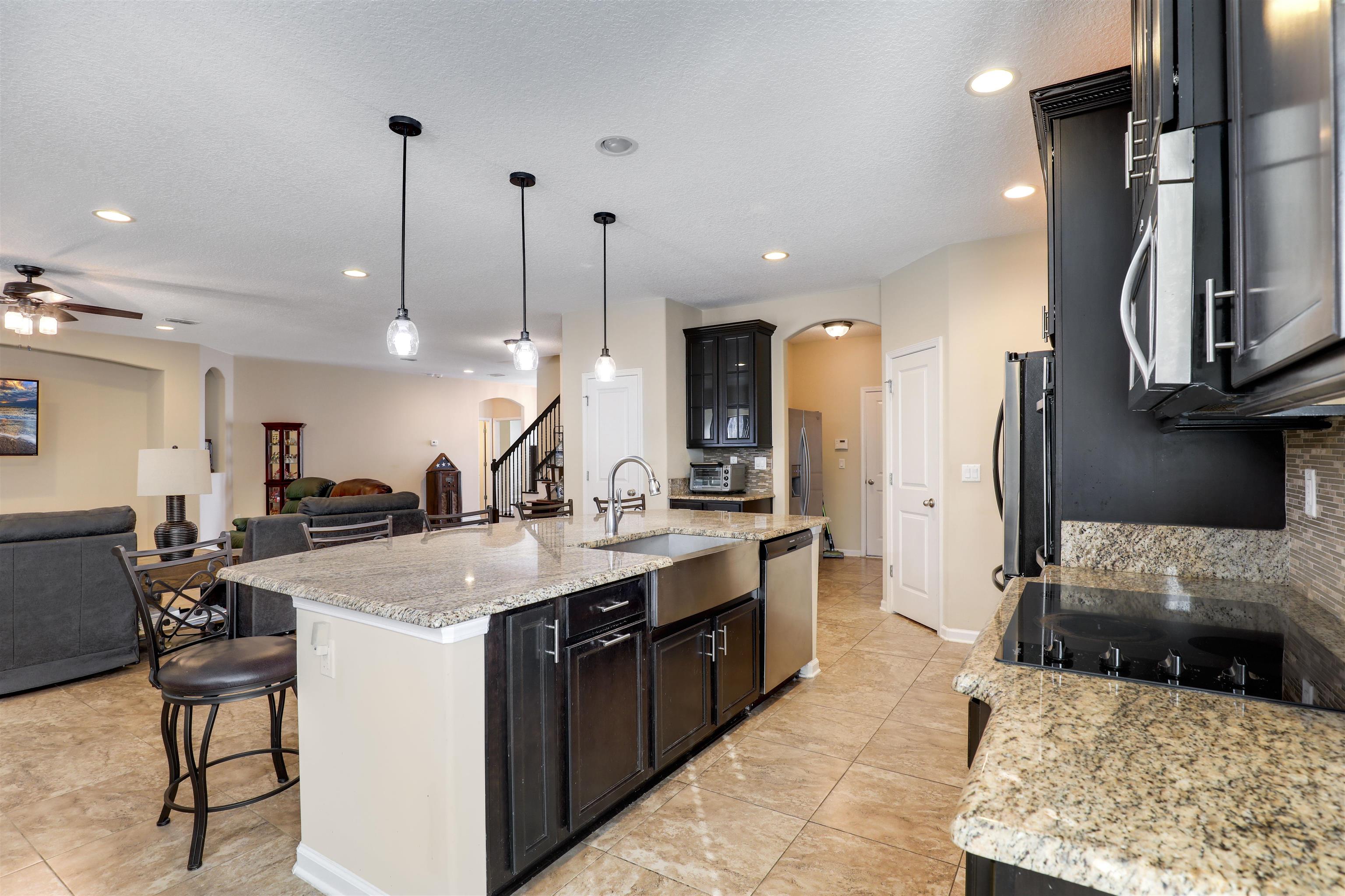 200 Ellsworth Circle St. Johns, FL 32259 - Photo 3 of 58 a large kitchen with stainless steel appliances kitchen island granite countertop a sink a stove and a refrigerator