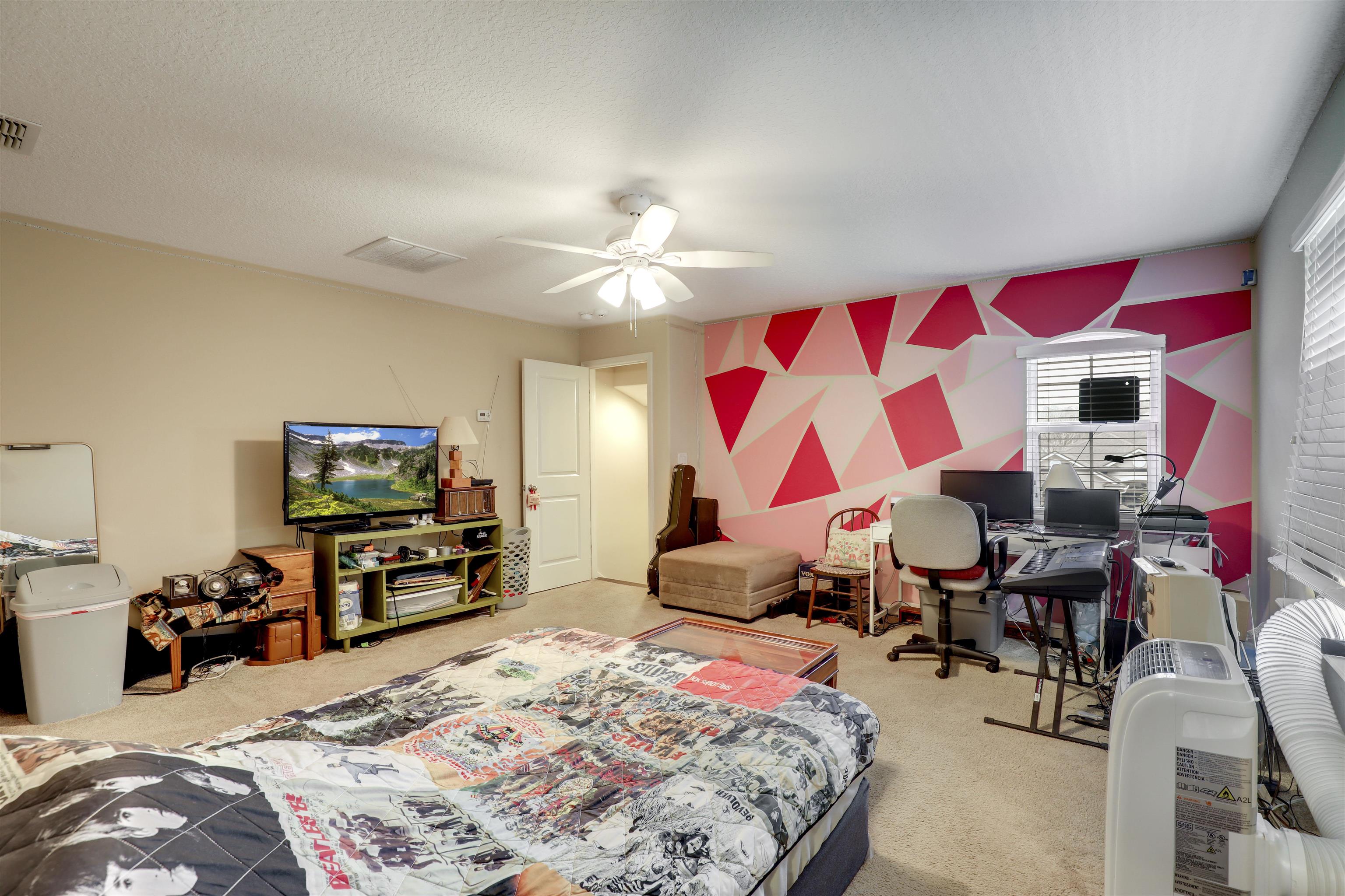 200 Ellsworth Circle St. Johns, FL 32259 - Photo 32 of 58 a bedroom with furniture and a flat screen tv