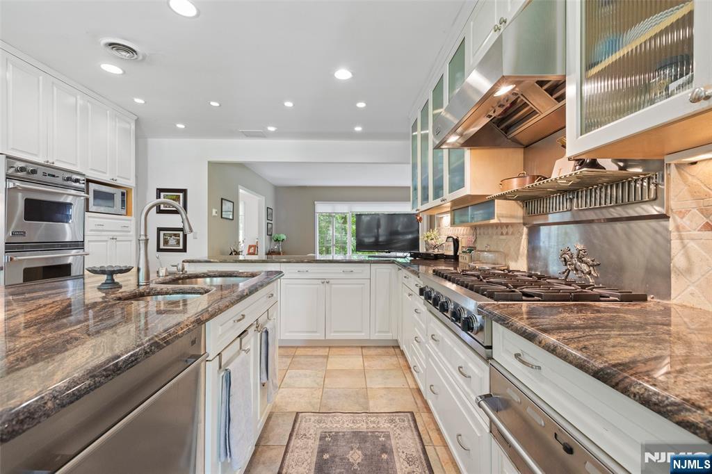 223 Terrace Road Franklin Lakes, NJ 07417 - Photo 11 of 35 a large kitchen with stainless steel appliances granite countertop a stove and a sink