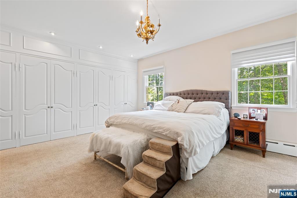 223 Terrace Road Franklin Lakes, NJ 07417 - Photo 15 of 35 a spacious bedroom with a bed and a table