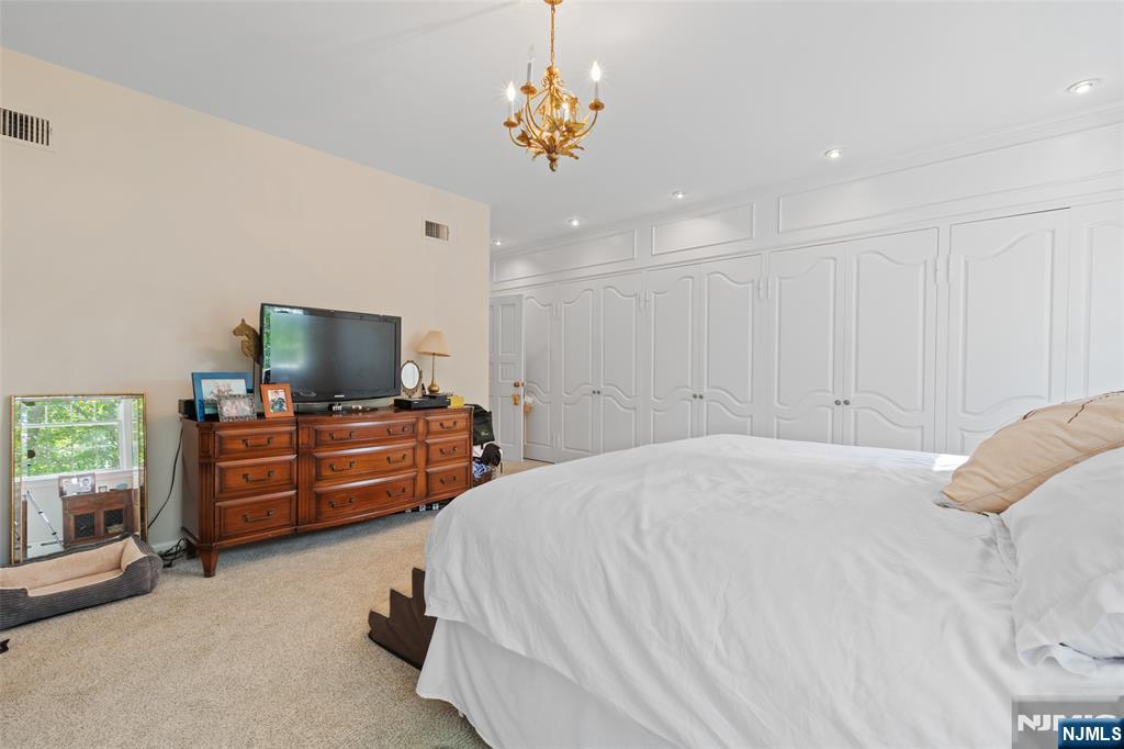 223 Terrace Road Franklin Lakes, NJ 07417 - Photo 16 of 35 a bedroom with furniture and flat screen tv