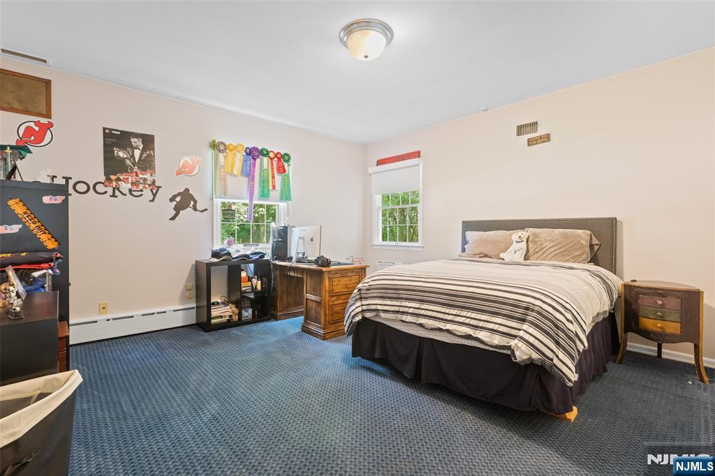 223 Terrace Road Franklin Lakes, NJ 07417 - Photo 18 of 35 a spacious bedroom with a bed and wooden floor