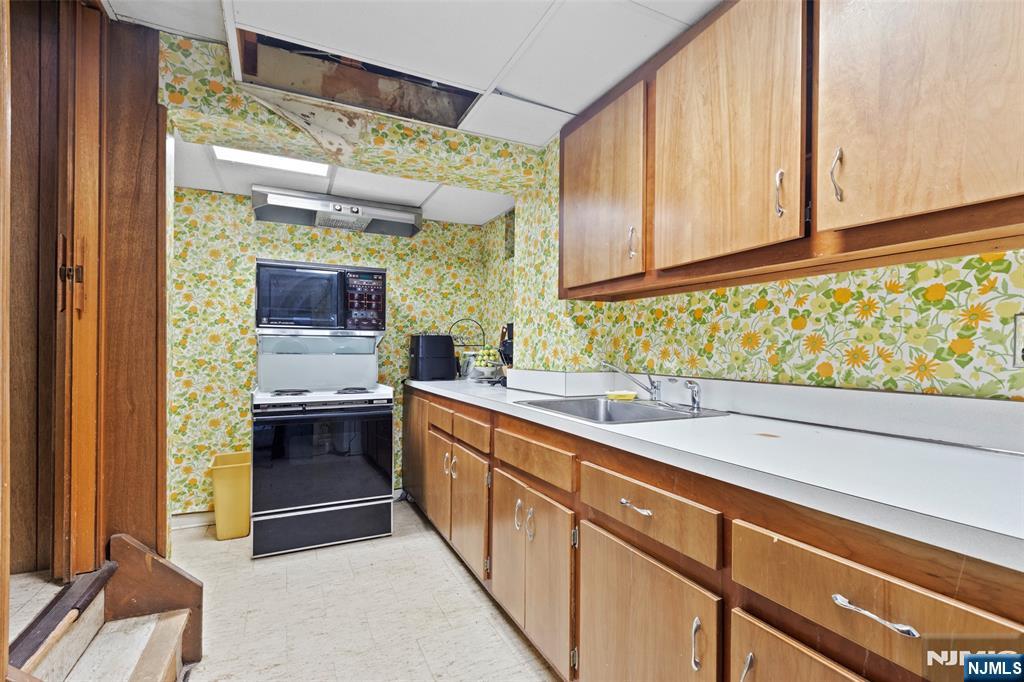 223 Terrace Road Franklin Lakes, NJ 07417 - Photo 28 of 35 a kitchen with a sink and a refrigerator
