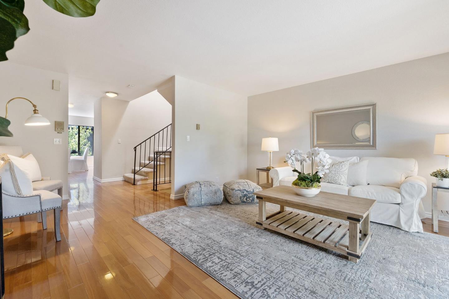 33 Park Road, Unit 13 Burlingame, CA 94010 - Photo 1 of 43 a living room with furniture and a table