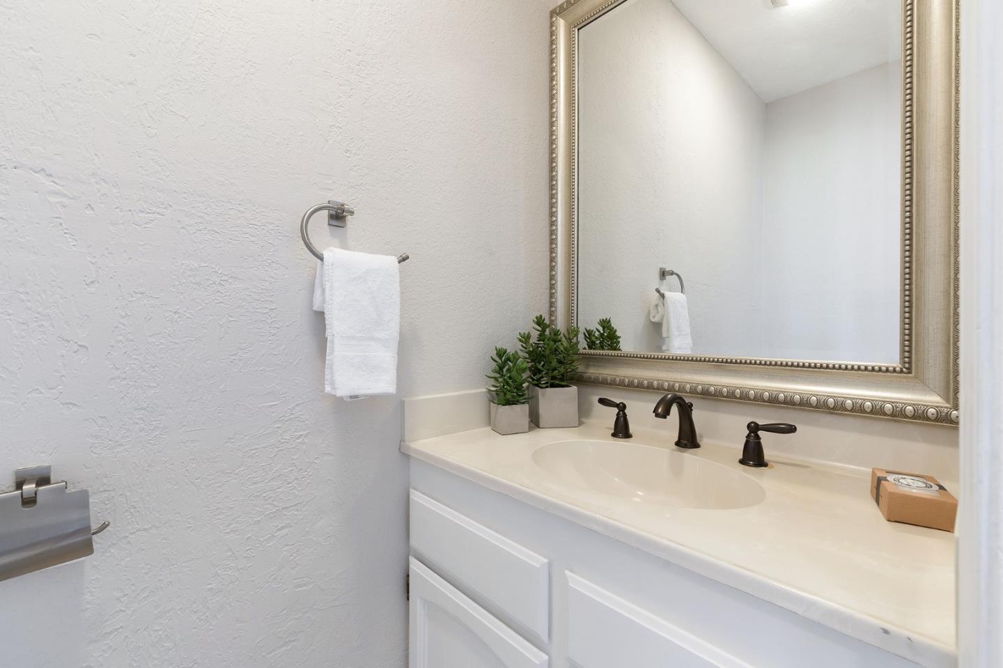 33 Park Road, Unit 13 Burlingame, CA 94010 - Photo 12 of 43 a bathroom with a sink and a mirror