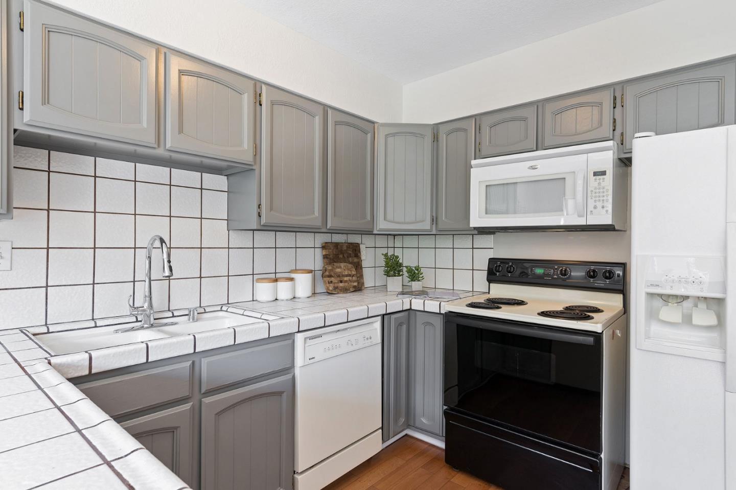 33 Park Road, Unit 13 Burlingame, CA 94010 - Photo 19 of 43 a kitchen with a sink stove and cabinets