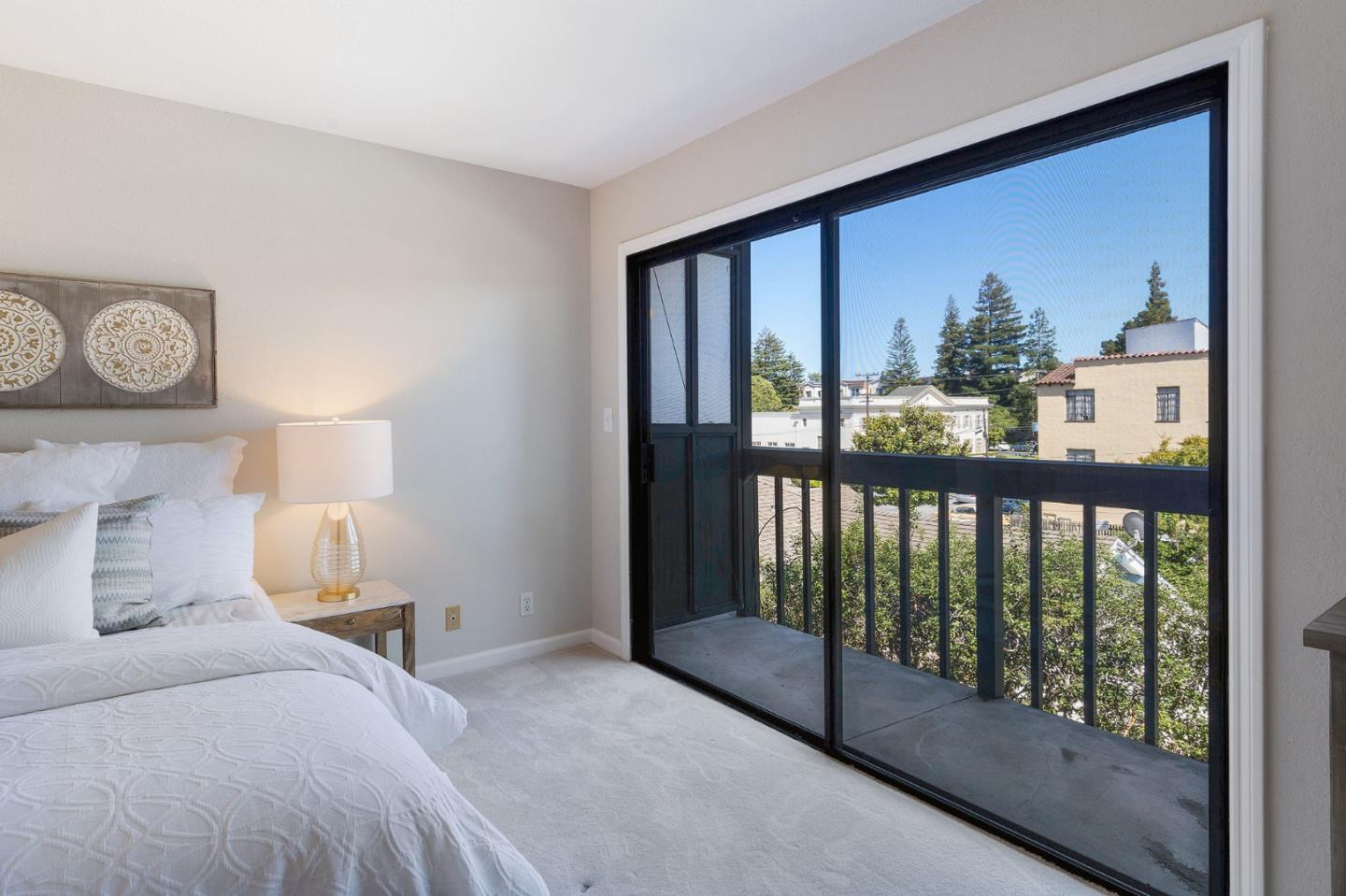 33 Park Road, Unit 13 Burlingame, CA 94010 - Photo 27 of 43 a bedroom with a large bed and a window