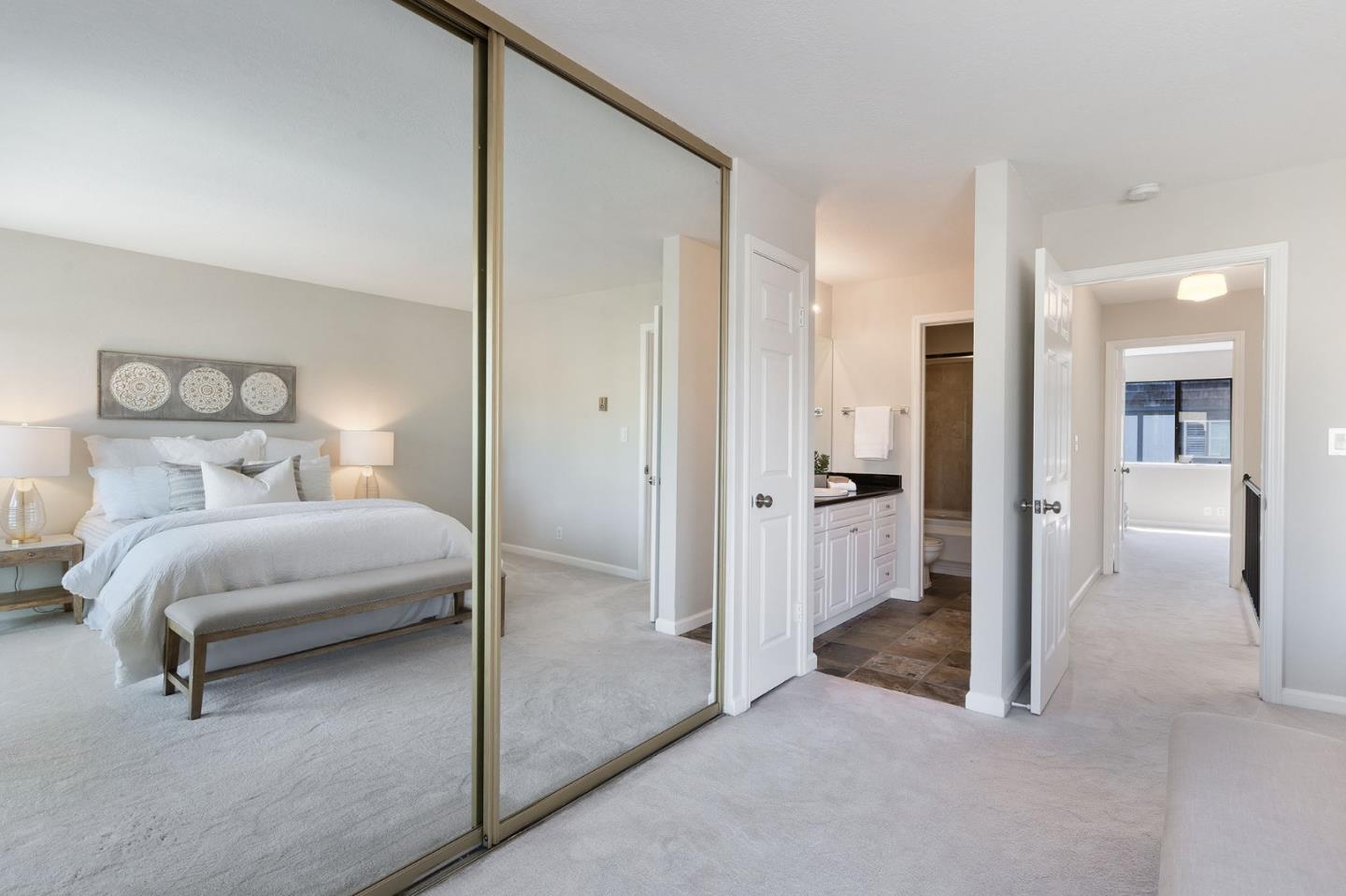 33 Park Road, Unit 13 Burlingame, CA 94010 - Photo 30 of 43 a bedroom with a bed and glass door