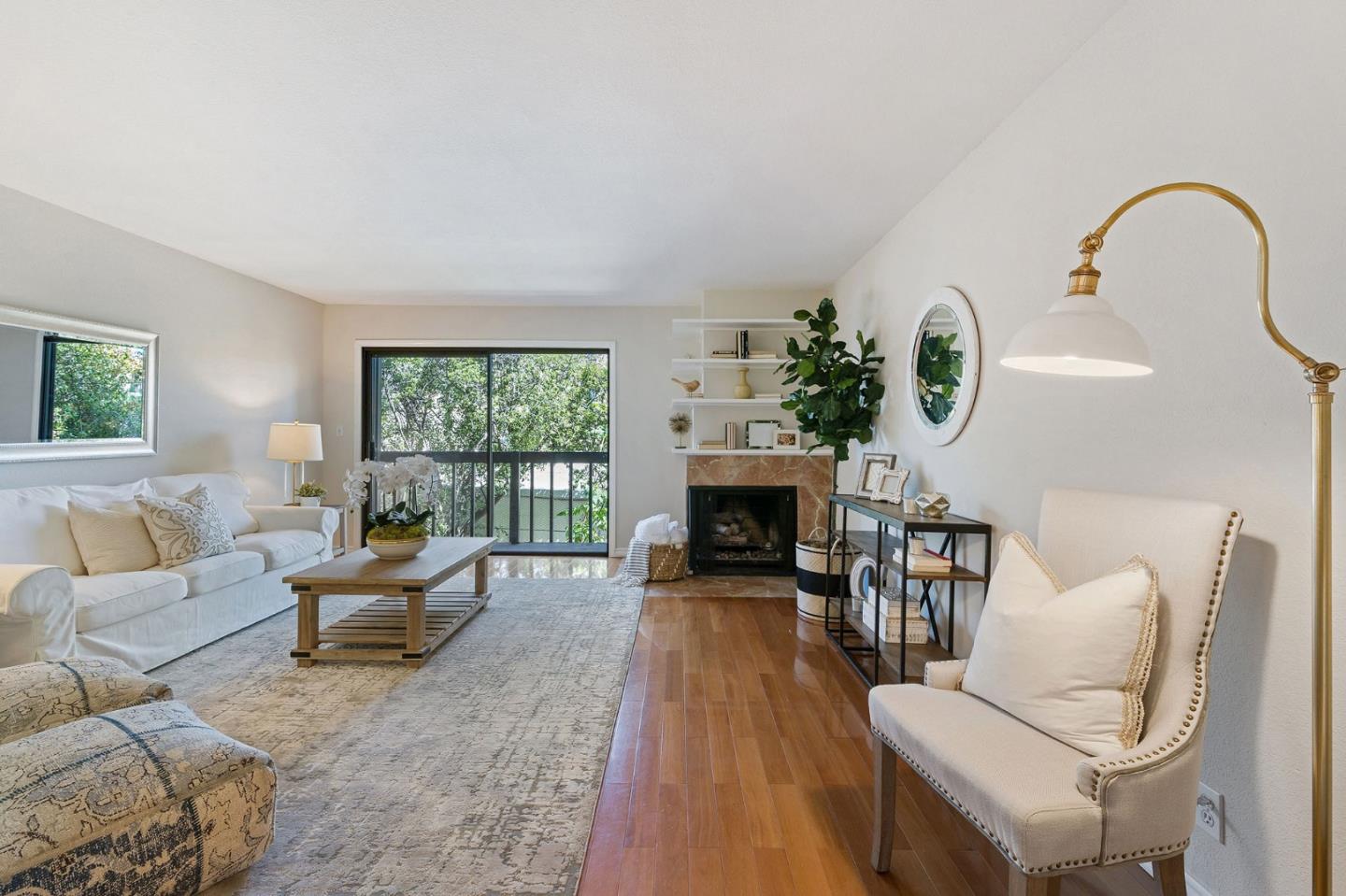 33 Park Road, Unit 13 Burlingame, CA 94010 - Photo 7 of 43 a living room with furniture a fireplace and a floor to ceiling window