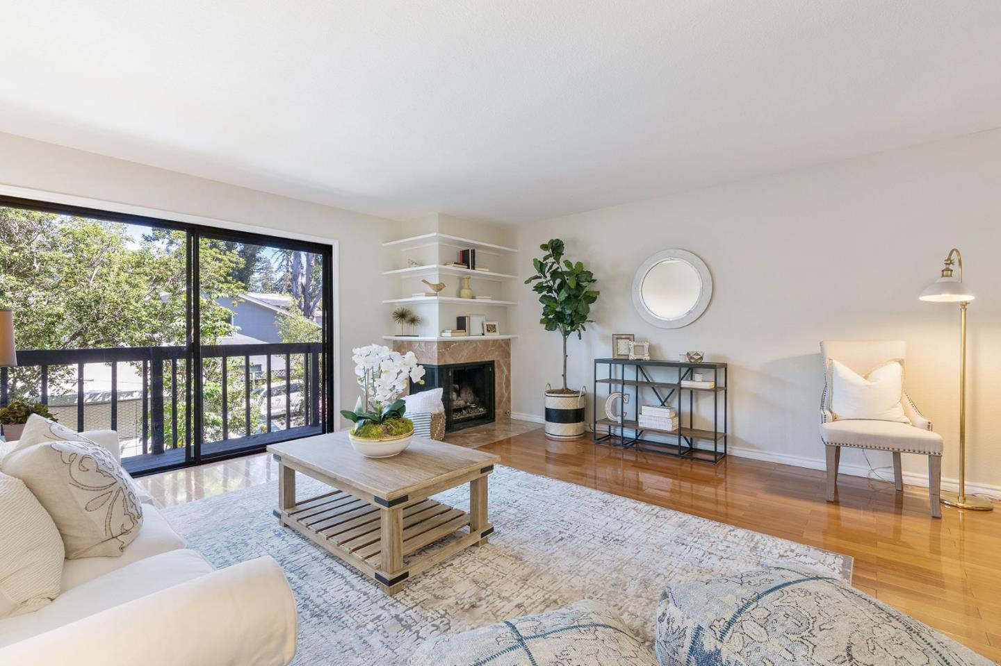 33 Park Road, Unit 13 Burlingame, CA 94010 - Photo 10 of 43 a living room with furniture large window and a fireplace