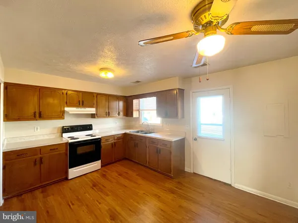a kitchen with stainless steel appliances granite countertop a sink and stove top oven