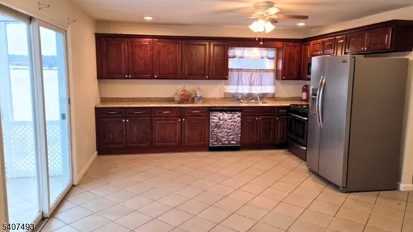 a kitchen with stainless steel appliances granite countertop a refrigerator and a sink