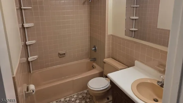 a bath room with a toilet and a bath tub