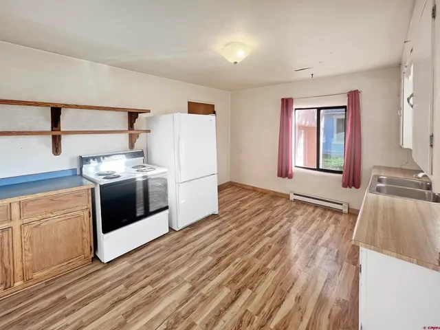 a kitchen with a stove a sink and a refrigerator