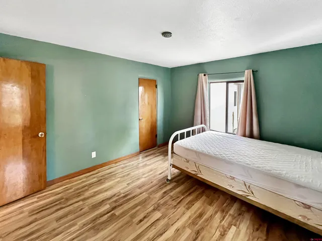 a bedroom with a bed and window