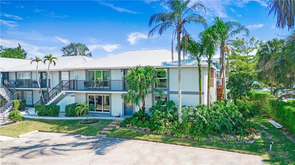 1560 Blue Point Avenue, Unit 3 Naples, FL 34102 - Photo 13 of 27 front view of a house with a yard