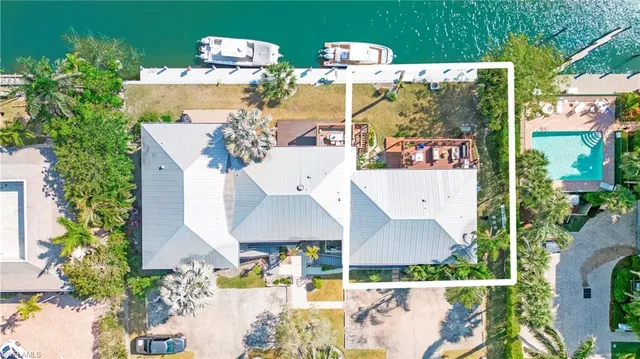 an aerial view of a house with swimming pool and outdoor space