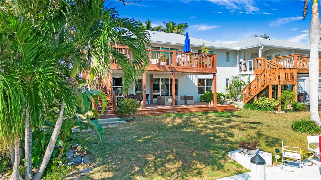 1560 Blue Point Avenue, Unit 3 Naples, FL 34102 - Photo 8 of 27 a view of a house with backyard