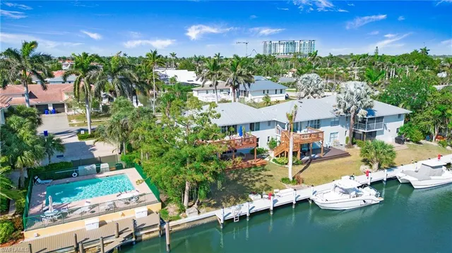 an aerial view of a house with swimming pool outdoor seating and yard