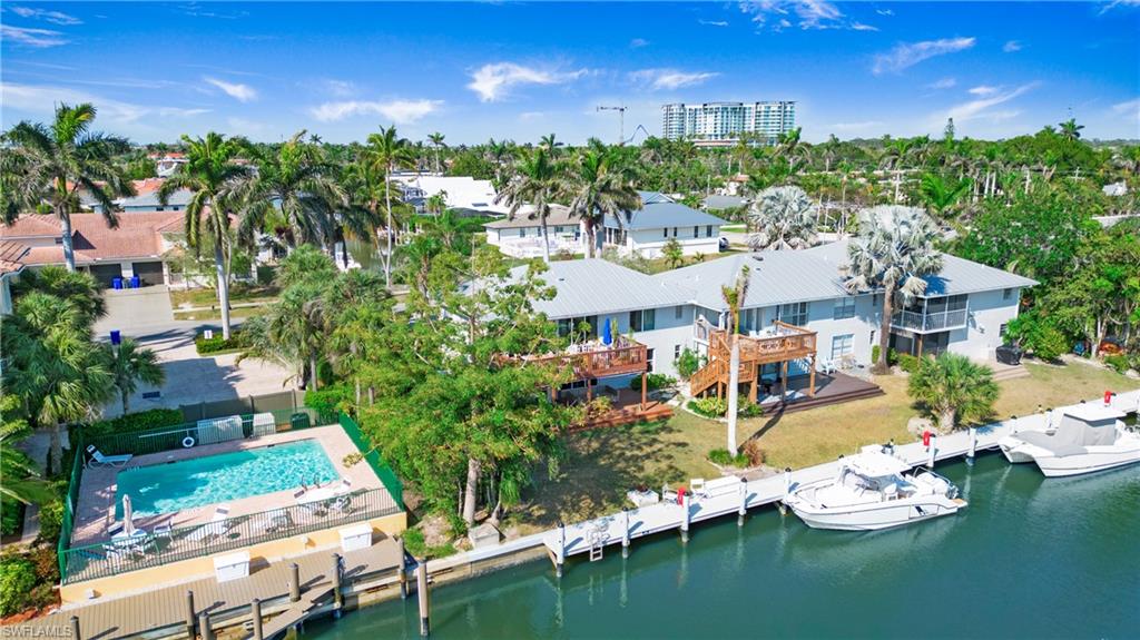 1560 Blue Point Avenue, Unit 3 Naples, FL 34102 - Photo 9 of 27 a view of a house with swimming pool outdoor seating