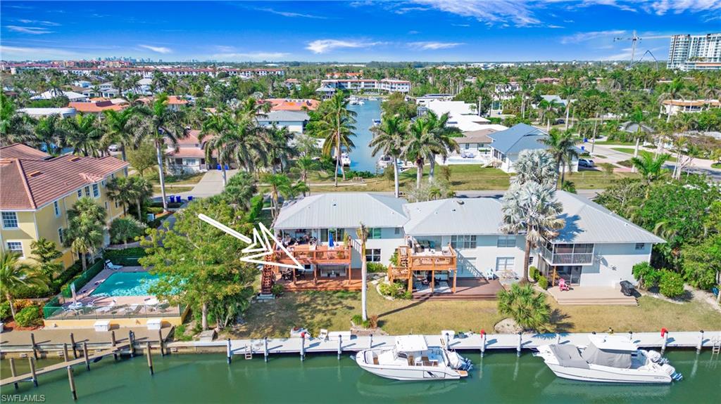 1560 Blue Point Avenue, Unit 3 Naples, FL 34102 - Photo 10 of 27 an aerial view of a house with swimming pool outdoor seating and yard