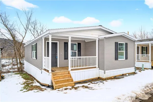 a front view of a house with a wooden fence