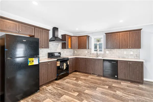 a kitchen with stainless steel appliances granite countertop a stove sink and cabinets