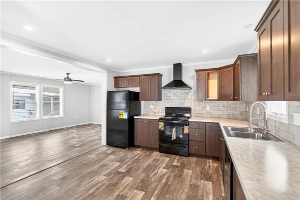 a kitchen with stainless steel appliances granite countertop a stove a sink and a microwave