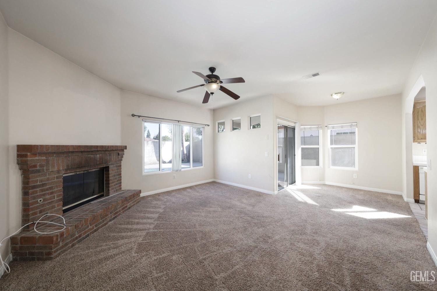 Undisclosed Address Bakersfield, CA 93312 - Photo 12 of 38 an empty room with windows and fireplace