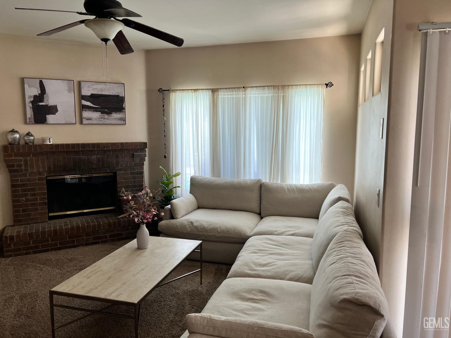 Undisclosed Address Bakersfield, CA 93312 - Photo 13 of 38 a living room with furniture and a fireplace