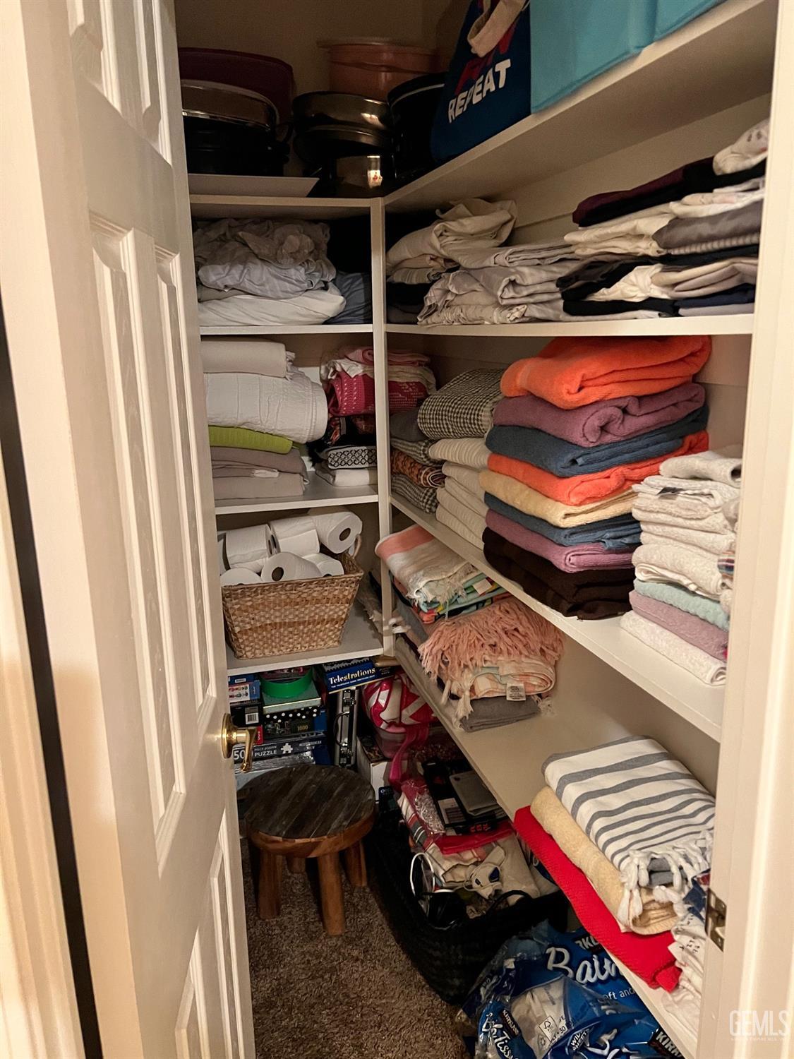 Undisclosed Address Bakersfield, CA 93312 - Photo 18 of 38 a view of walk in closet with clothes and shoes