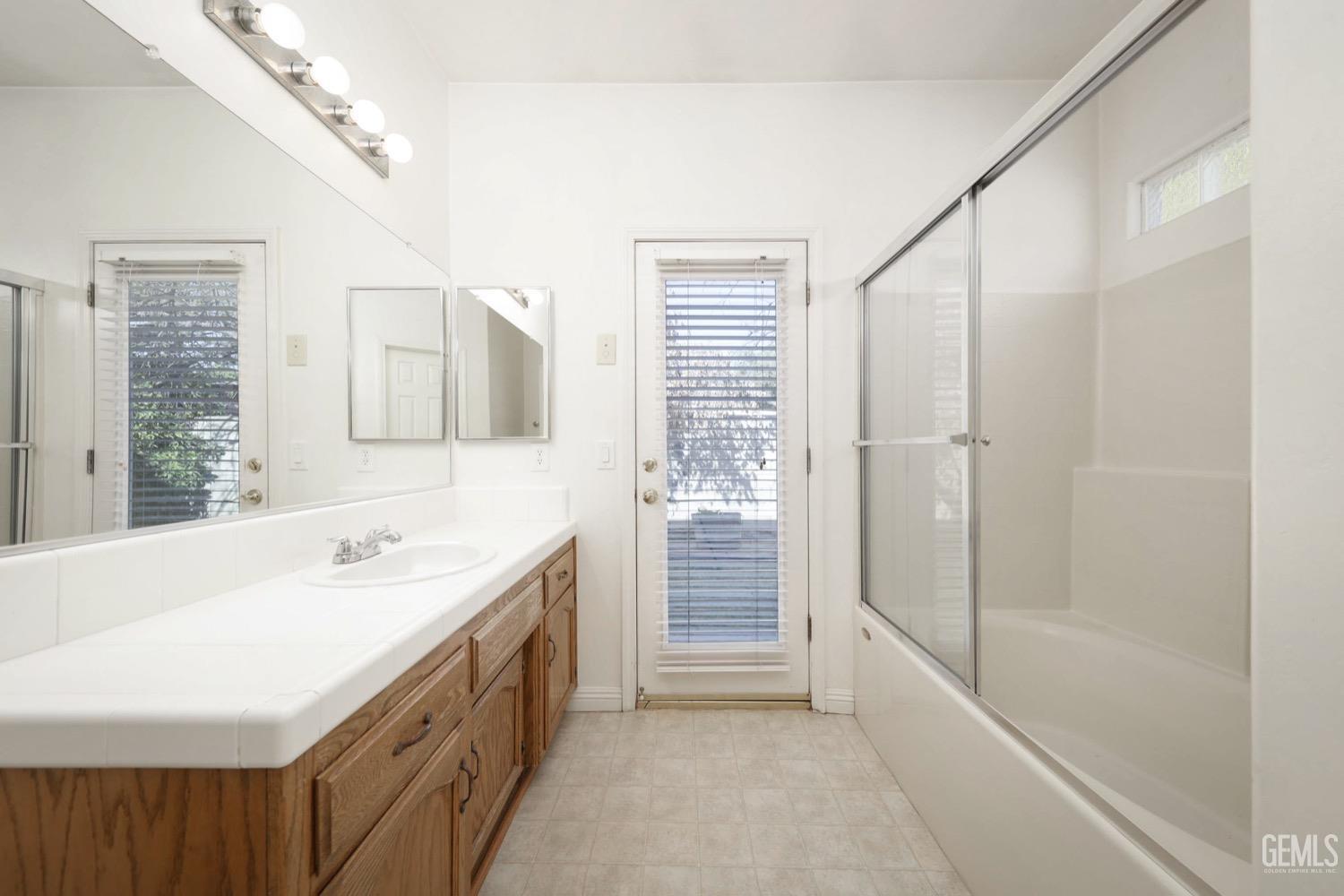 Undisclosed Address Bakersfield, CA 93312 - Photo 23 of 38 a spacious bathroom with a tub sink and mirror