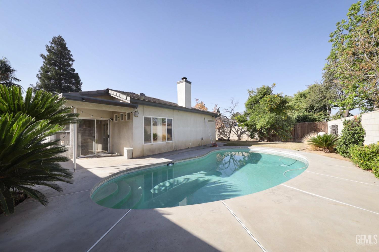 Undisclosed Address Bakersfield, CA 93312 - Photo 36 of 38 a front view of a house with a garden and trees