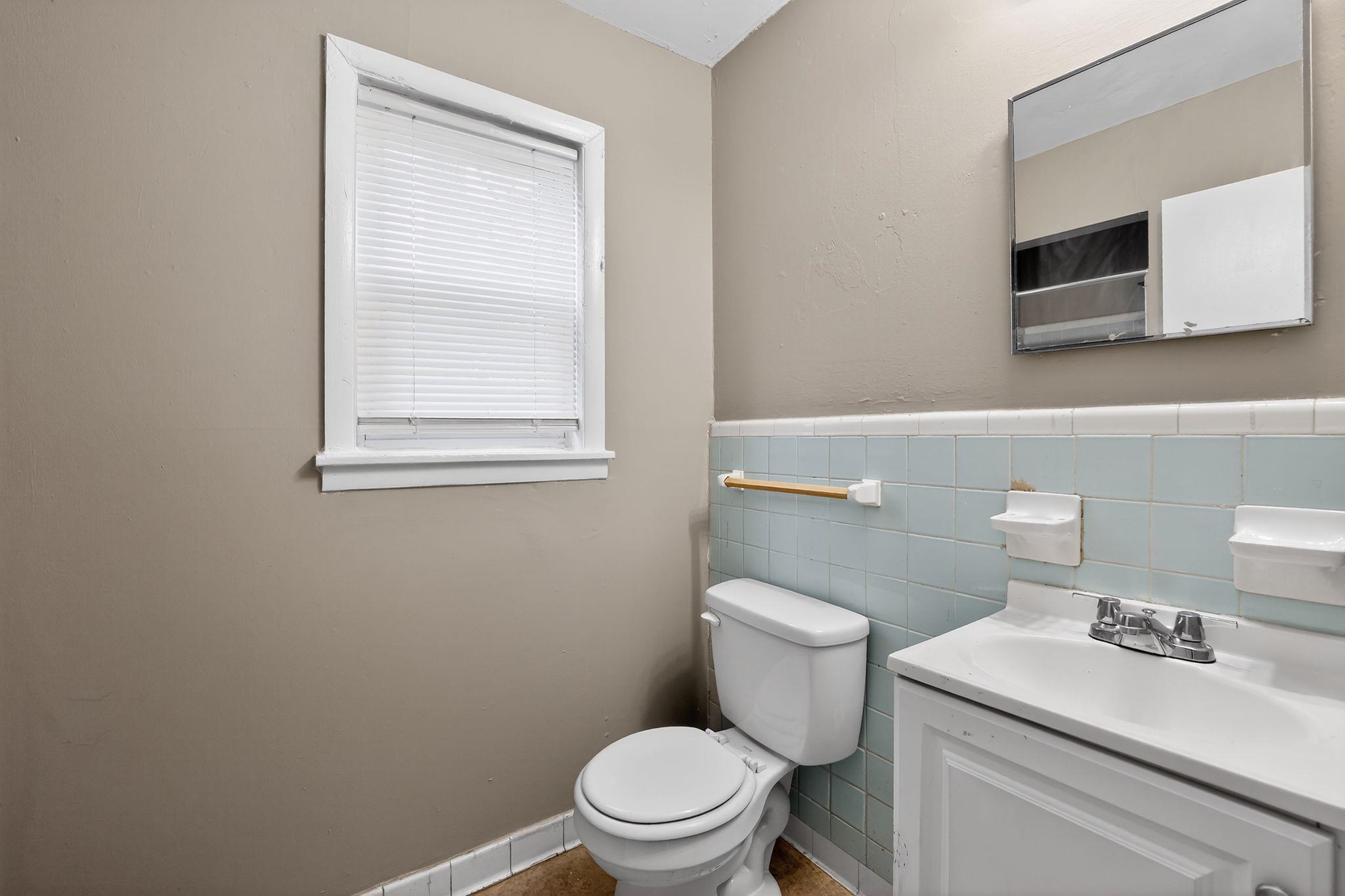 4646 Applegate Road Memphis, TN 38109 - Photo 11 of 37 a white toilet sitting next to a bathroom sink