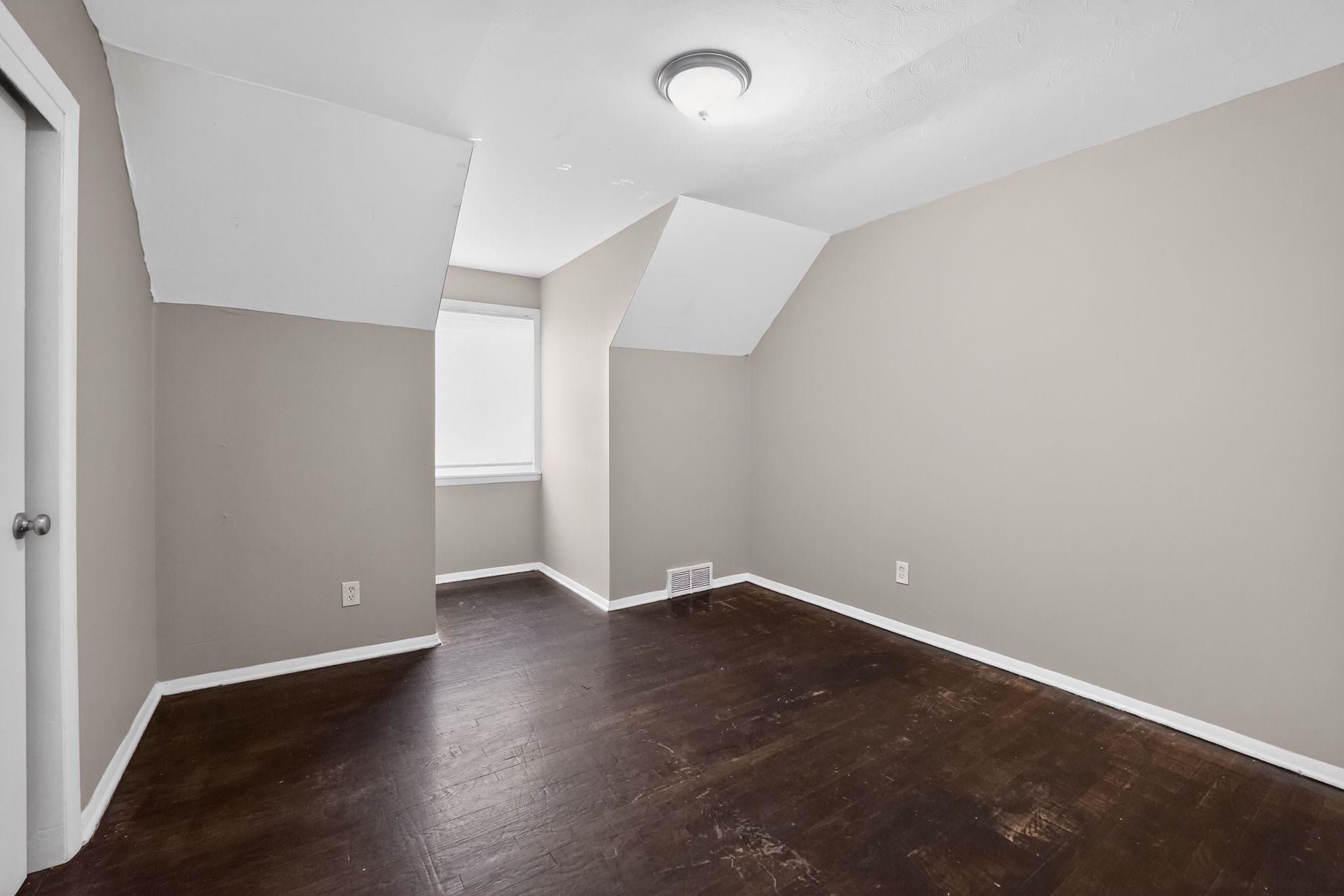 4646 Applegate Road Memphis, TN 38109 - Photo 12 of 37 an empty room with wooden floor and windows