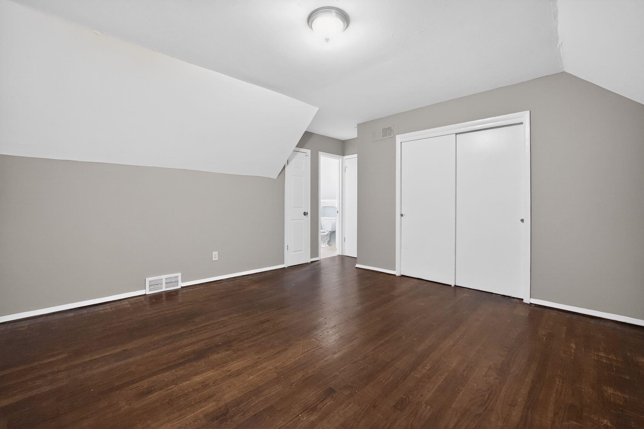 4646 Applegate Road Memphis, TN 38109 - Photo 13 of 37 an empty room with wooden floor and windows