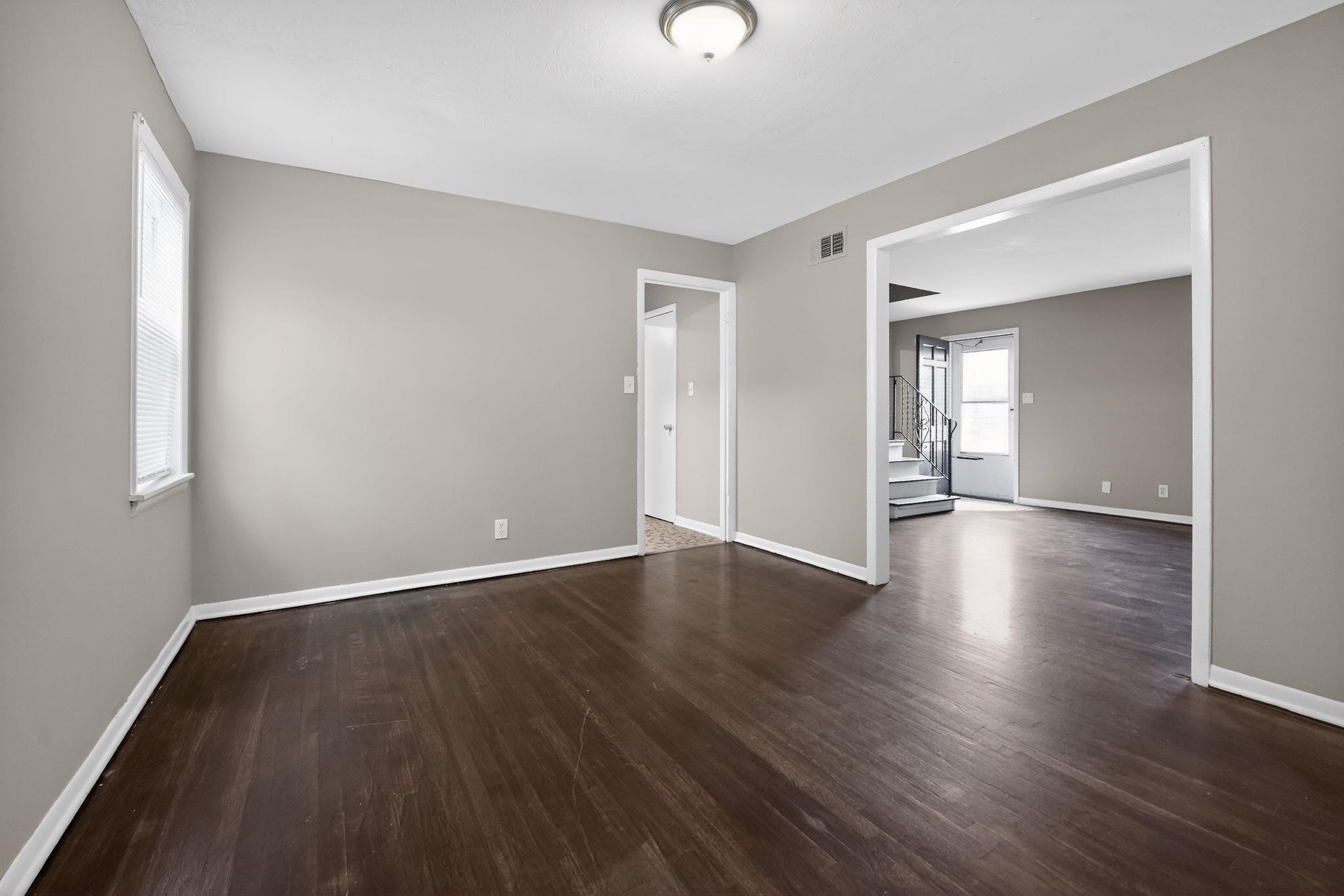 4646 Applegate Road Memphis, TN 38109 - Photo 20 of 37 a view of an empty room with wooden floor and a window