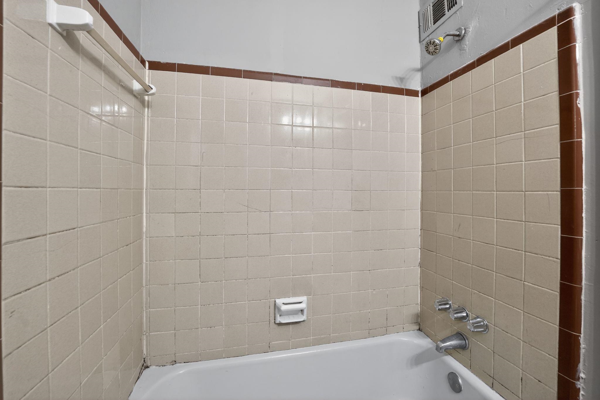4646 Applegate Road Memphis, TN 38109 - Photo 22 of 37 a bathroom with a shower and a bathtub