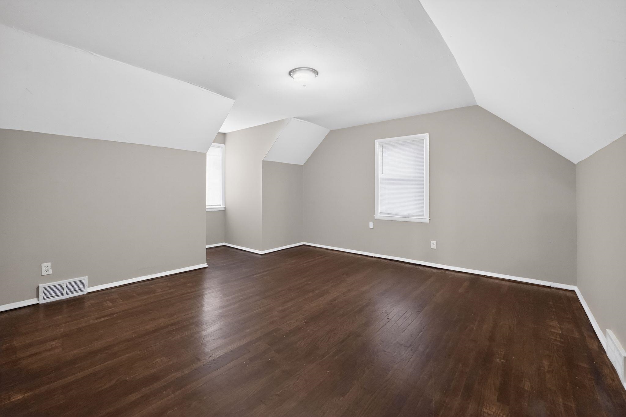 4646 Applegate Road Memphis, TN 38109 - Photo 24 of 37 an empty room with wooden floor and windows