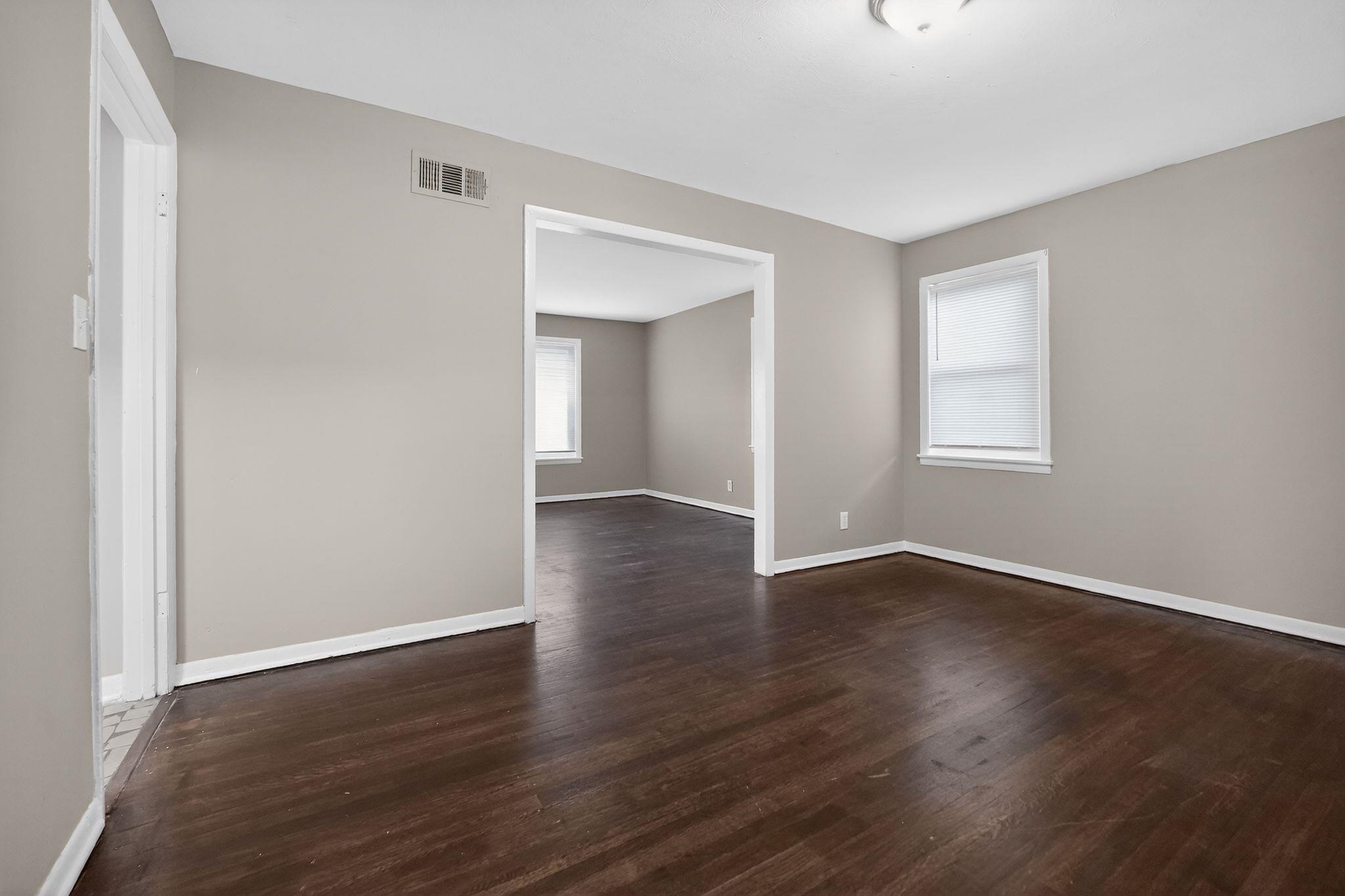 4646 Applegate Road Memphis, TN 38109 - Photo 33 of 37 an empty room with wooden floor and windows