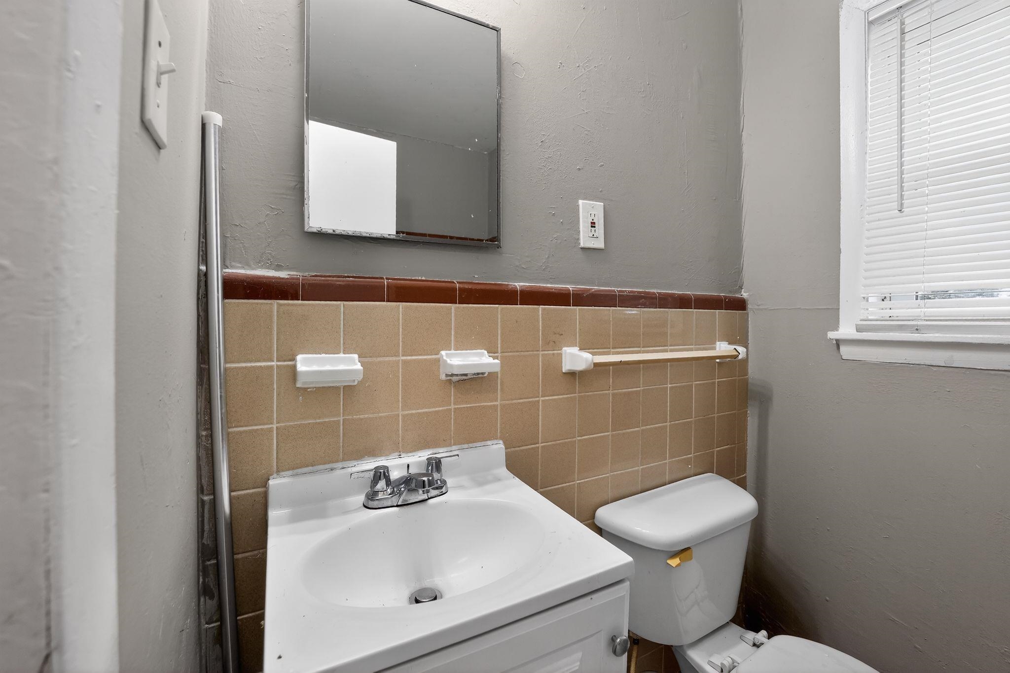 4646 Applegate Road Memphis, TN 38109 - Photo 8 of 37 a bathroom with a toilet sink and mirror