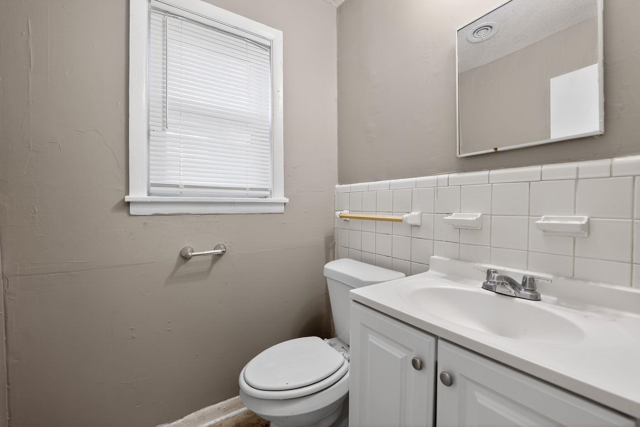 4646 Applegate Road Memphis, TN 38109 - Photo 9 of 37 a bathroom with a sink a toilet and mirror